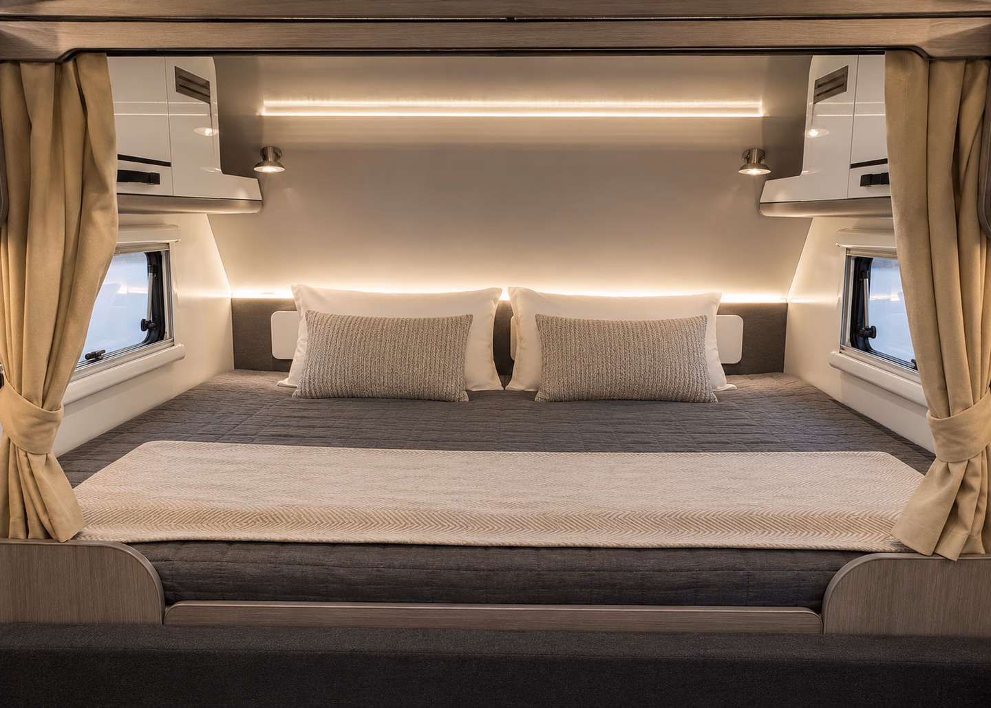 Kalowen 250 main bed with integrated lighting and overhead storage.